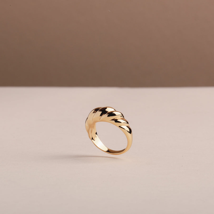 A gold croissant ring starting in size 4, made in the USA