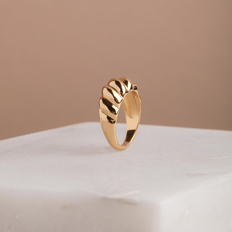 A gold croissant ring starting in size 4, made in the USA